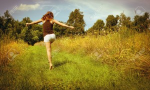 17796513-Back-of-young-woman-skipping-down-nature-walk-way-Stock-Photo